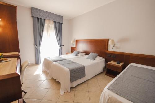 Letto o letti in una camera di Hotel Le Palme