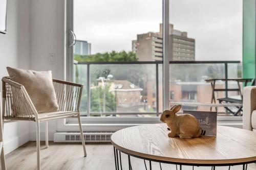 a toy rabbit sitting on a table in a living room at Initial / Lapin / Downtown Qc in Quebec City