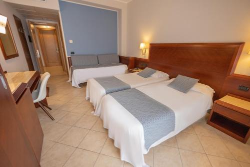 Letto o letti in una camera di Hotel Le Palme