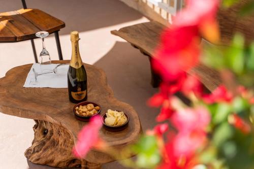 a bottle of champagne and a bowl of food on a table at Le Antiche Dimore di Cadia in Ugento