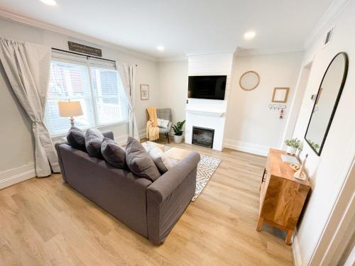 a living room with a couch and a fireplace at Retreat at Fenwick in Leonardtown