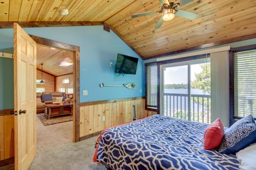 a bedroom with a bed and a ceiling fan at Lakefront Outing Home Private Dock and Volleyball! in Emily