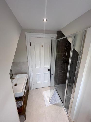 a bathroom with a shower and a sink at Roe Retreat 