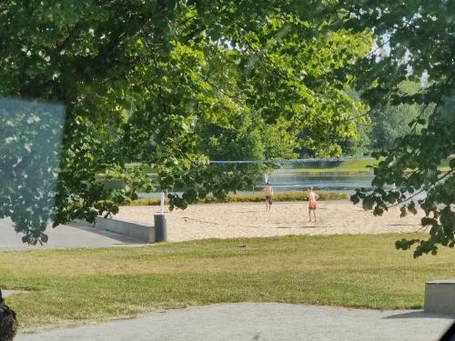 two people playing a game of volley ball on a beach at Nina`s GuestHouse, Jämsä City, 160 m2, Include x2 Himos Ski Pass in Jämsä
