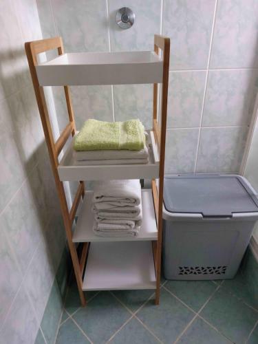 a shelf in a bathroom with towels and a sink at Apartment Rama in Poreč