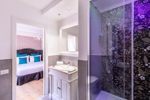 a purple bathroom with a sink and a shower at Trastevere Paper Suites in Rome