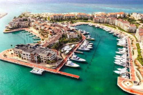 an aerial view of a marina with boats in the water at Thematic beach apartment in CapCana area in Punta Cana