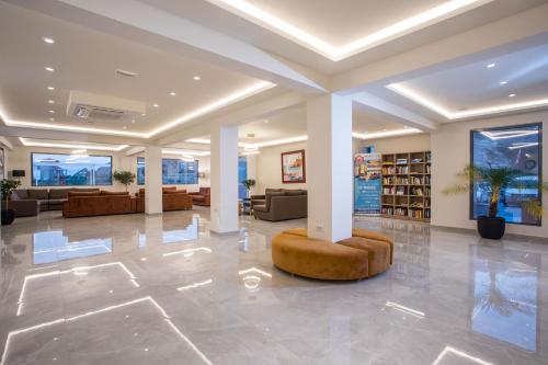 a lobby with a library with couches and a couch at Lardos Bay Hotel in Lardos