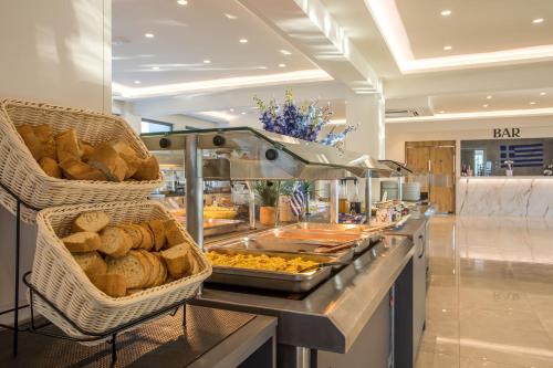 a buffet line with bread and pastries in a store at Lardos Bay Hotel in Lardos