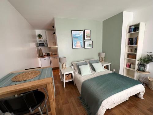 a bedroom with a bed and a desk in it at Le studio d'Alery - au coeur de la ville - 16Bis in Annecy