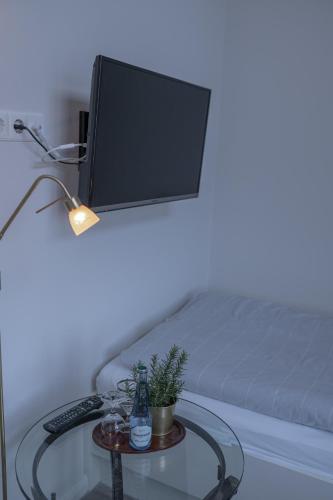 a table with a computer on a bed with a lamp at Hotel Seehof Norderney OHG in Norderney