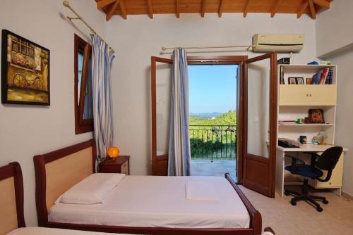 a bedroom with a bed and a desk and a window at Albatros Villa in Alonnisos