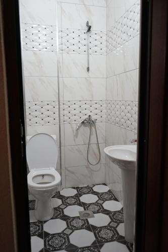 a bathroom with a toilet and a sink at Center Side in Prizren