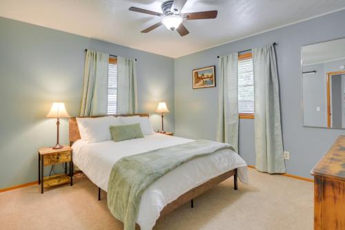 a bedroom with a bed and a ceiling fan at Rogers Vacation Rental about 7 Mi to Downtown in Rogers