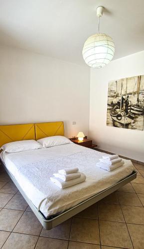 a bedroom with a bed with towels on it at Le Cave Apartment in Sirolo