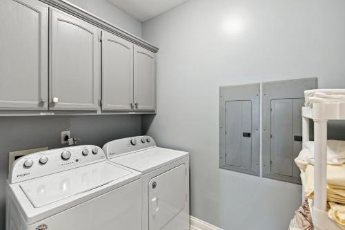 a white laundry room with a washer and dryer at Smyrna Home with Pool and Hot Tub! 20 Mi to Nashville! in Smyrna
