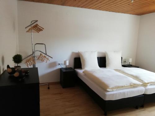 a bedroom with a large bed with white sheets at Ferienwohnung Sauerland in Drolshagen