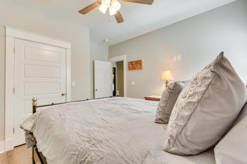 a bedroom with a bed with a ceiling fan at Russellville Home Near Hiking and Lake Access! in Russellville