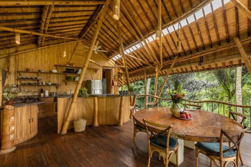 a kitchen and dining room with a table and chairs at Leaf House 3bds BambooVilla Pool in Bringkit