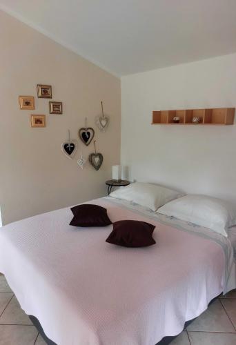 a bedroom with a white bed with two pillows on it at Apartment Rama in Poreč