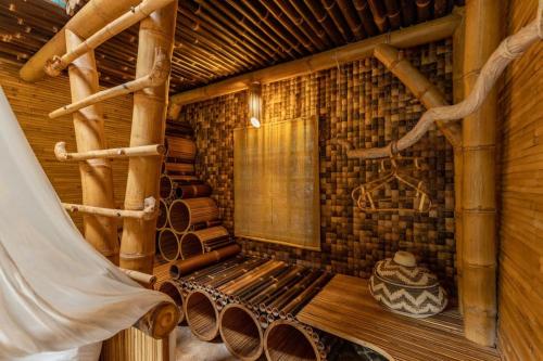 a room with a bench in a log cabin at Leaf House 3bds BambooVilla Pool in Bringkit