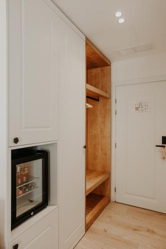 a living room with a built in closet and a fireplace at Seaside Hotel in Vlorë