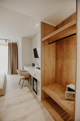 a room with a wooden partition with a desk at Seaside Hotel in Vlorë