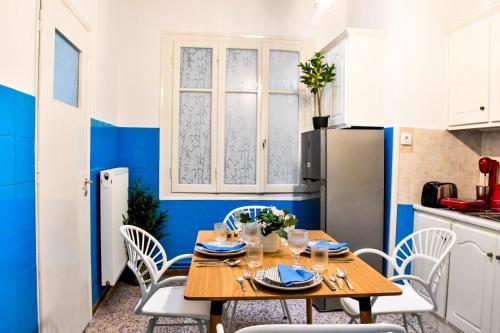 a kitchen and dining room with a wooden table and chairs at Aqua Mare Luxury Apartments in Amfilochia