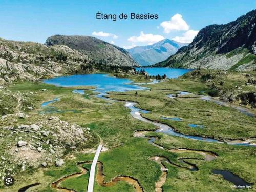 a view of a river in a valley with mountains at Studio confort montagne in Aulus-les-Bains