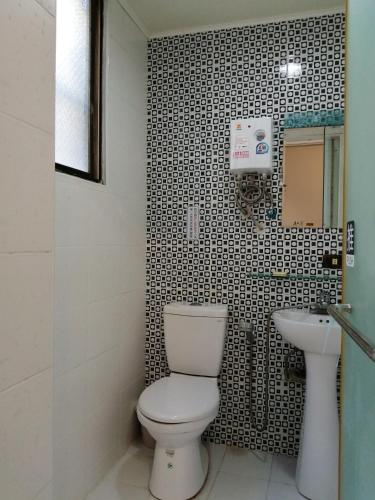 a bathroom with a toilet and a sink at Rowan House in Taichung