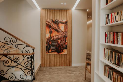 a hallway with bookshelves and a painting on the wall at Seaside Hotel in Vlorë