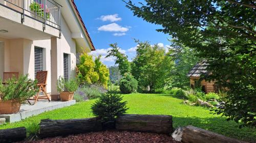 a backyard with a yard of green grass at HomeSlovenia - your Home in the Heart of Slovenia in Selca