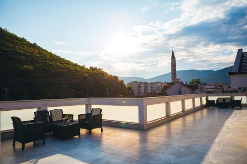a balcony with chairs and a table on a building at Elegant Studio Apartments Lasta in Mostar