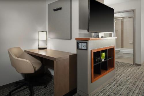 a hotel room with a desk and a television at Hyatt Place-Dallas/Arlington in Arlington