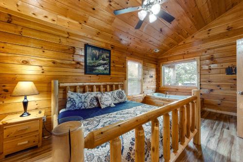 a bedroom with a bed in a log cabin at Blackberry Bijou in Pigeon Forge