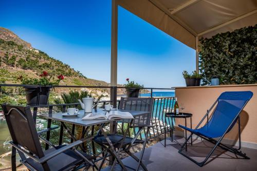 a table and chairs on a balcony with a view of the ocean at Suite Altamarea "Sea View Studios" in Castellammare del Golfo