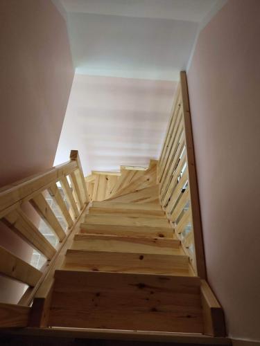 a set of stairs in a room with a ceiling at Domek Żegary in Sejny