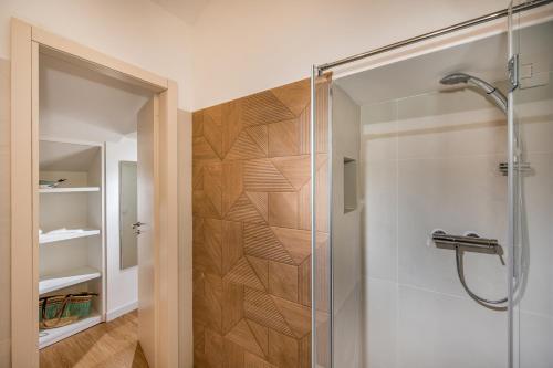 a bathroom with a shower with a glass door at Suite Altamarea "Sea View Studios" in Castellammare del Golfo