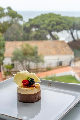 a piece of food sitting on a white plate at Parador de Mazagón in Mazagón