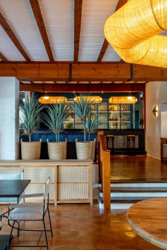 a restaurant with potted plants on a counter at Parador de Mazagón in Mazagón