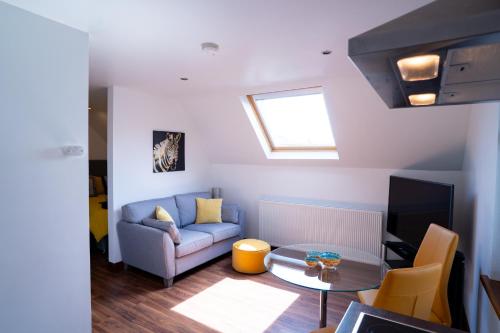 a living room with a couch and a table at Cherry Tree Apartment 