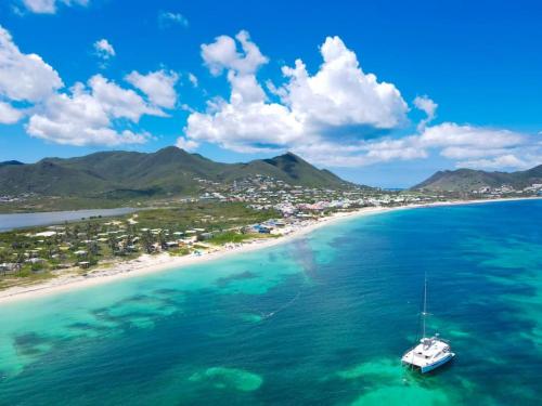 a boat in the water near a beach at Mahi Mahi direct access to Orient Bay beach in Orient Bay