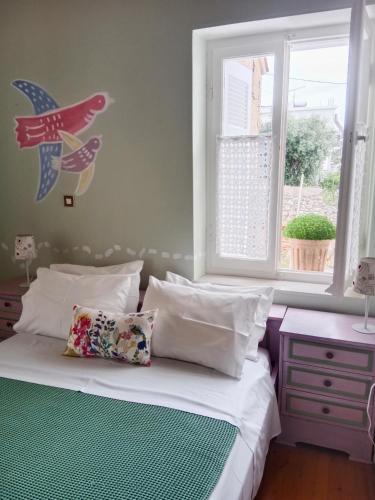 a bedroom with a bed and a window with a plane on the wall at George Traditional House in Pylos