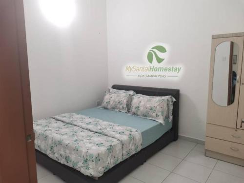 a small bedroom with a bed and a dresser at MySantai Homestay Padang Serai in Padang Serai