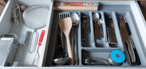a drawer filled with utensils and utensils at Patogus poilsis prie ežero/Comfortable rest in Visaginas