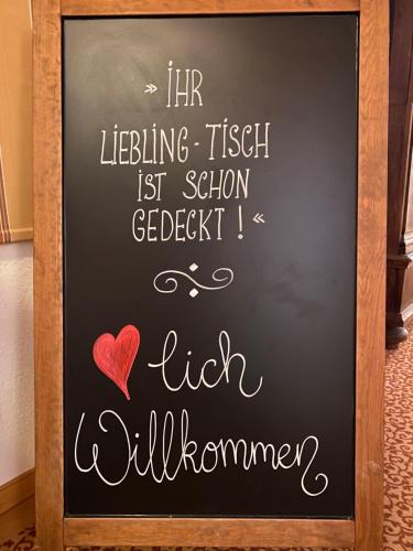 a chalkboard with a sign that says hr lifting fish last school getbeck i at Hotel Sonnenhügel in Bad Bevensen