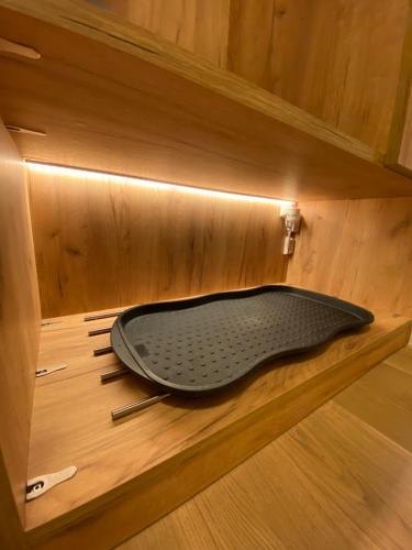 a bathtub in a wooden cabinet with a mat in it at Hotel Sonnenhügel in Bad Bevensen