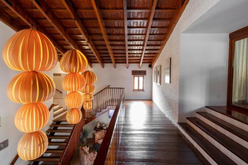 a hallway with orange lanterns hanging from the ceiling at Parador de Mazagón in Mazagón