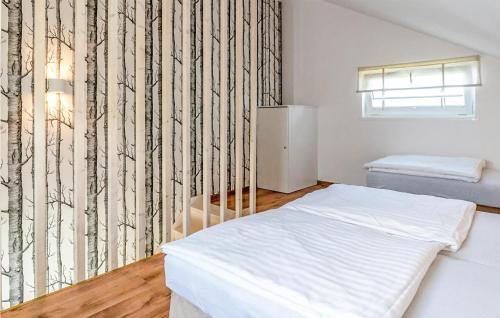 a bedroom with a white bed and a black and white wallpaper at 1 Bedroom Pet Friendly Home In Dabki in Dąbki