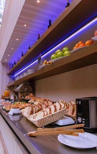 a bakery with lots of bread and fruit on display at Howard Johnson Plaza by Wyndham Buenos Aires Florida Street in Buenos Aires